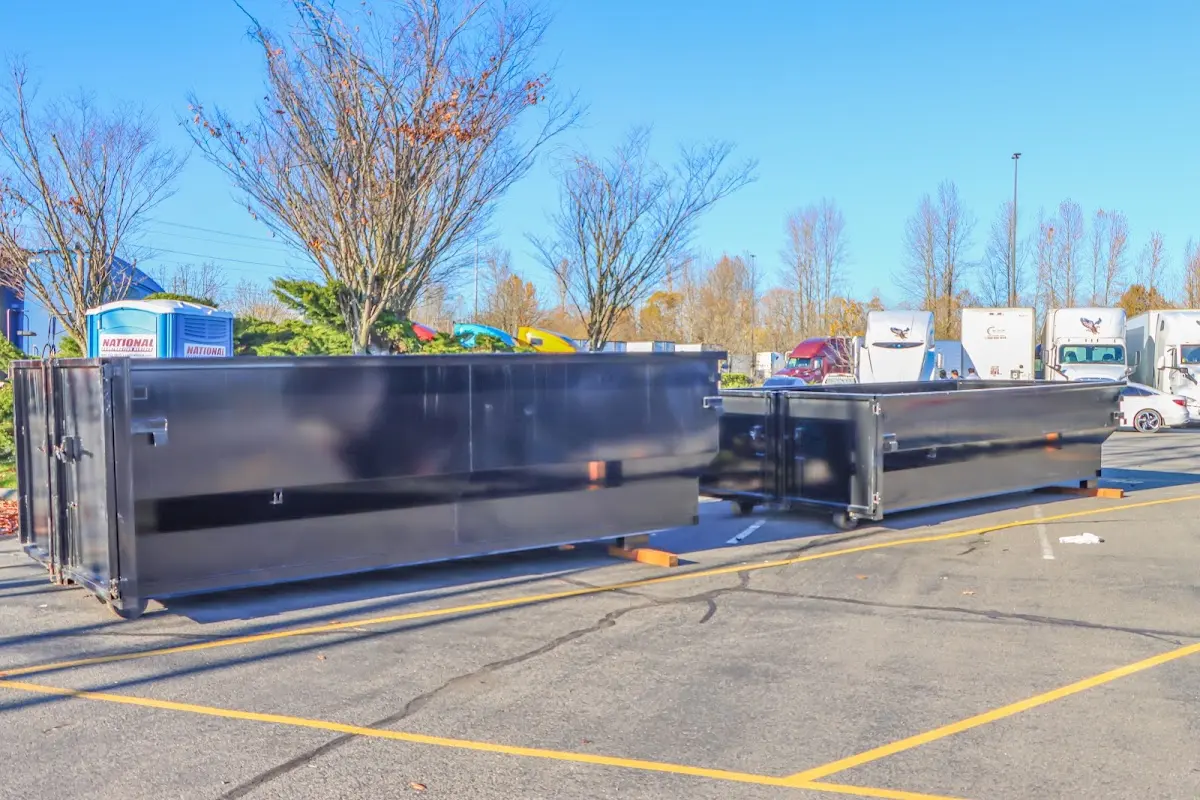 Professional dumpster rental service with roll-off container on residential driveway in Davenport